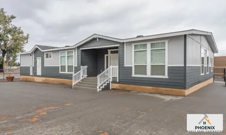 Double-wide manufactured home with new skirting and foundation setup in Mesa, Arizona